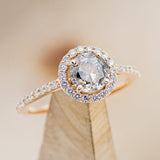 Shown here is "Aurora", a salt & pepper diamond women's engagement ring with a diamond halo