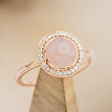 Shown here is The "Terra", a rose quartz women's engagement ring with a diamond halo