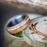 Shown here is  "Remmy", a custom, handcrafted men's wedding ring featuring authentic whiskey barrel wood & an elk antler inlay, shown here on a titanium band. Additional inlay options are available upon request.-"REMMY" WEDDING RING IN AUTHENTIC WHISKEY BARREL WOOD & ELK ANTLER INLAY (available in titanium, silver, black zirconium & 14K white, rose, or yellow gold) - Staghead Designs - Antler Rings By Staghead Designs