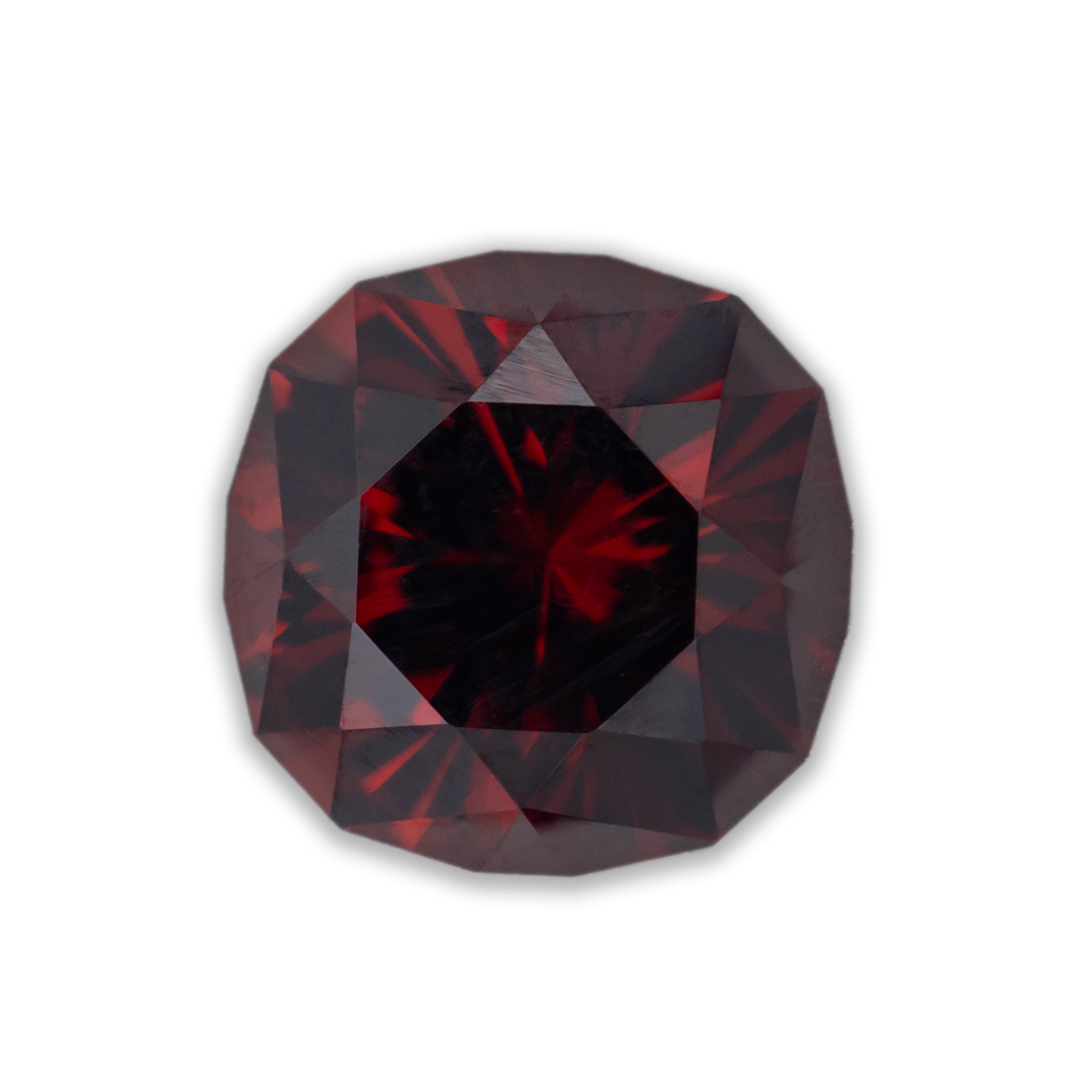 Faceted red garnet on a white background