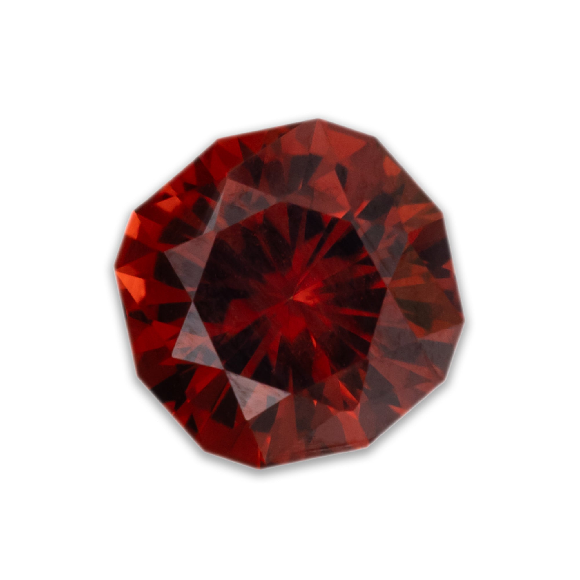 Faceted red garnet on a white background