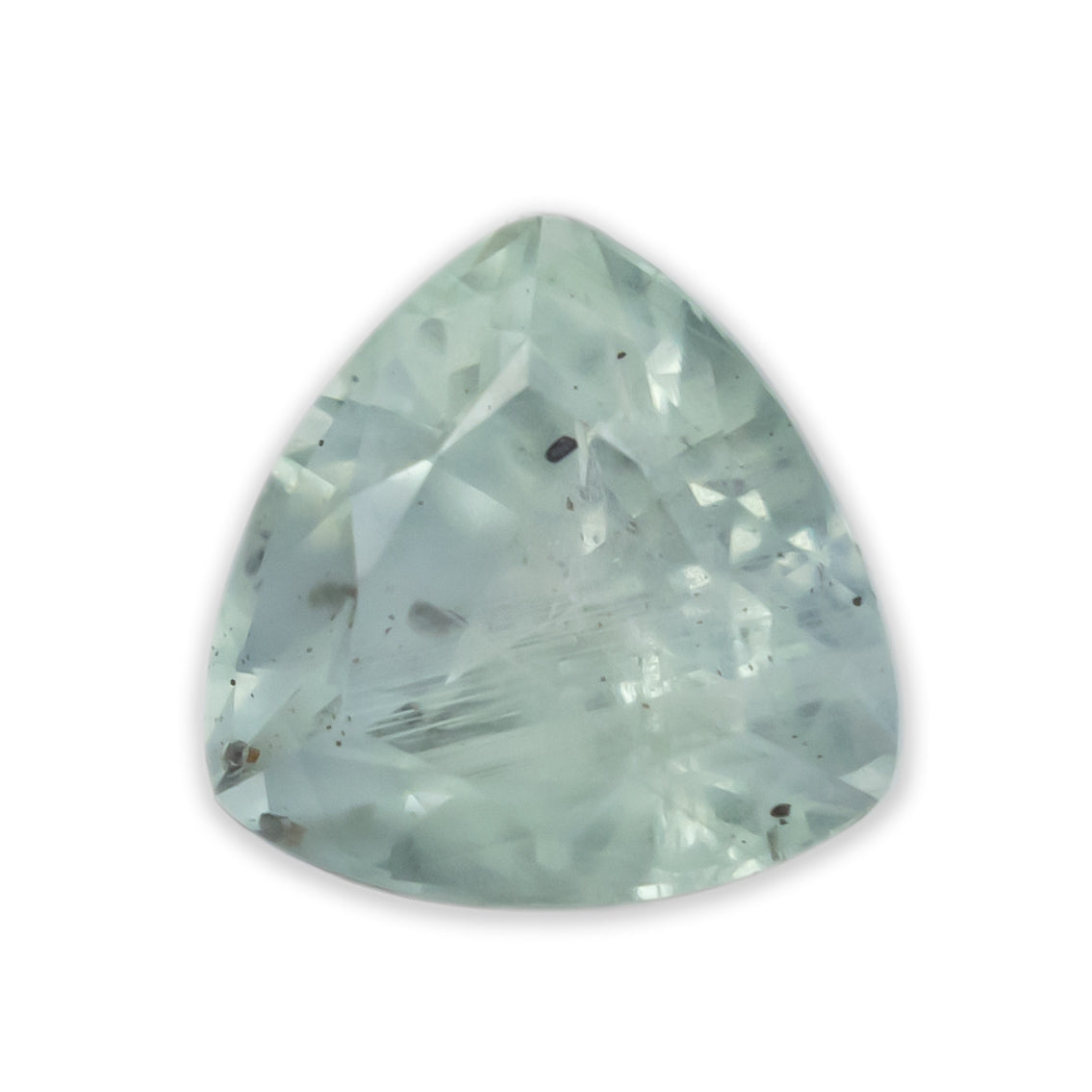 A trillion cut blue sapphire against a white background
