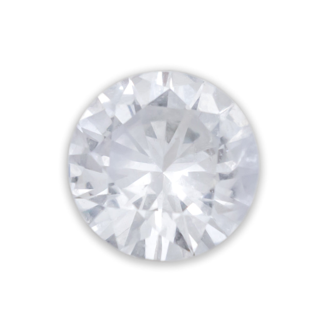A round cut white sapphire against a white background