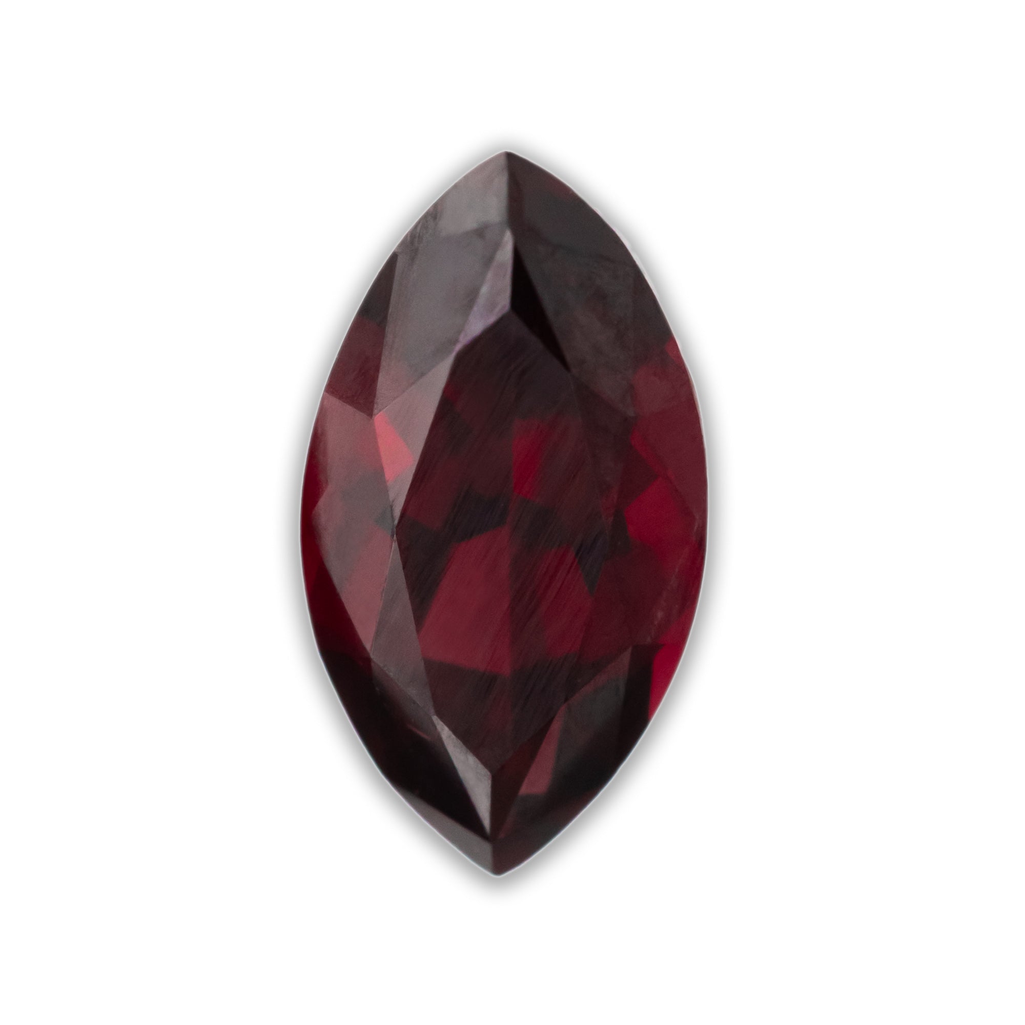 Marquise-shaped red garnet on a white background