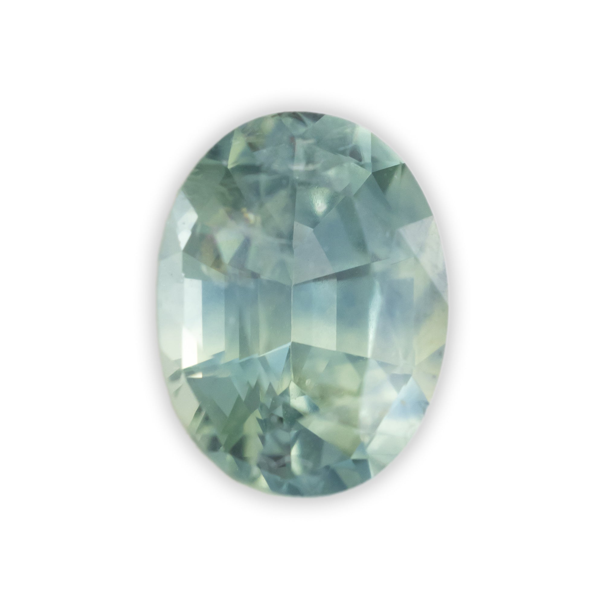 Faceted green gemstone on a white background