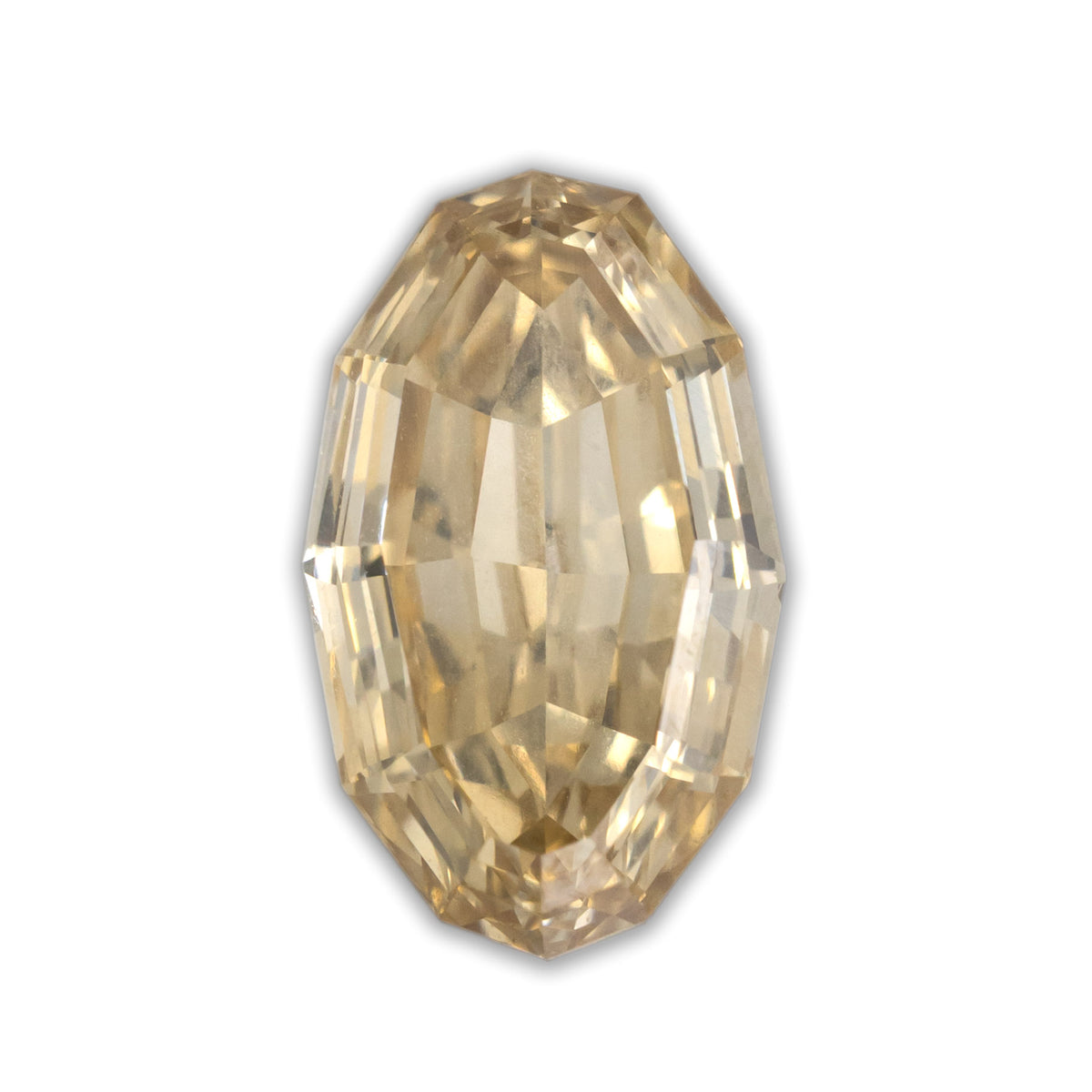 Oval cut diamond with champagne color on a white background