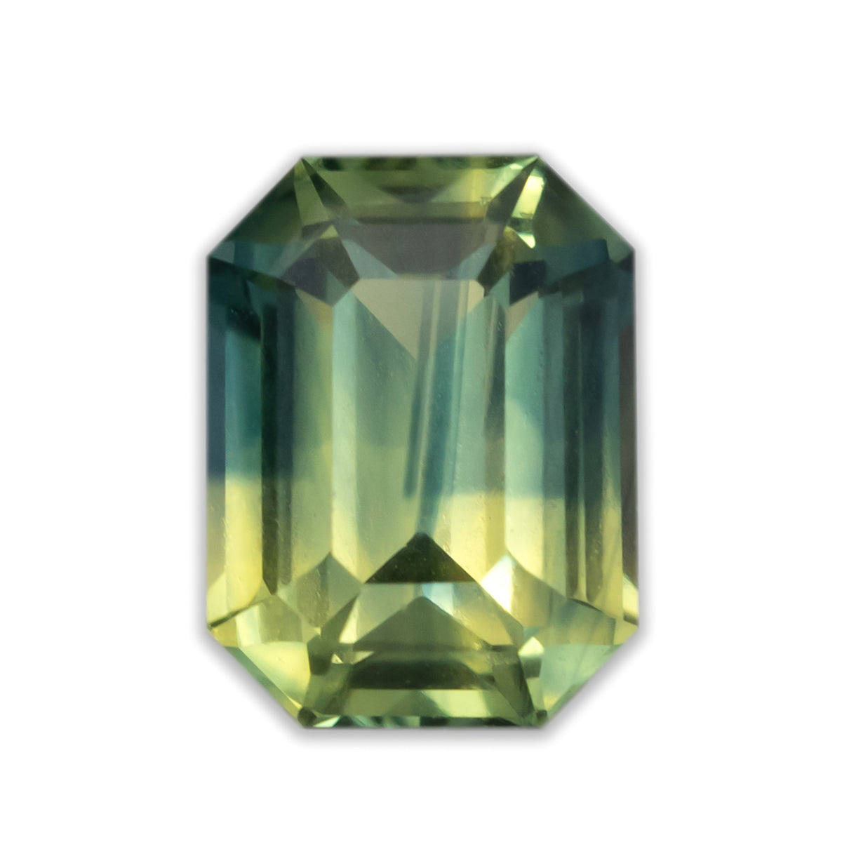 Emerald cut yellow-green sapphire on a white background