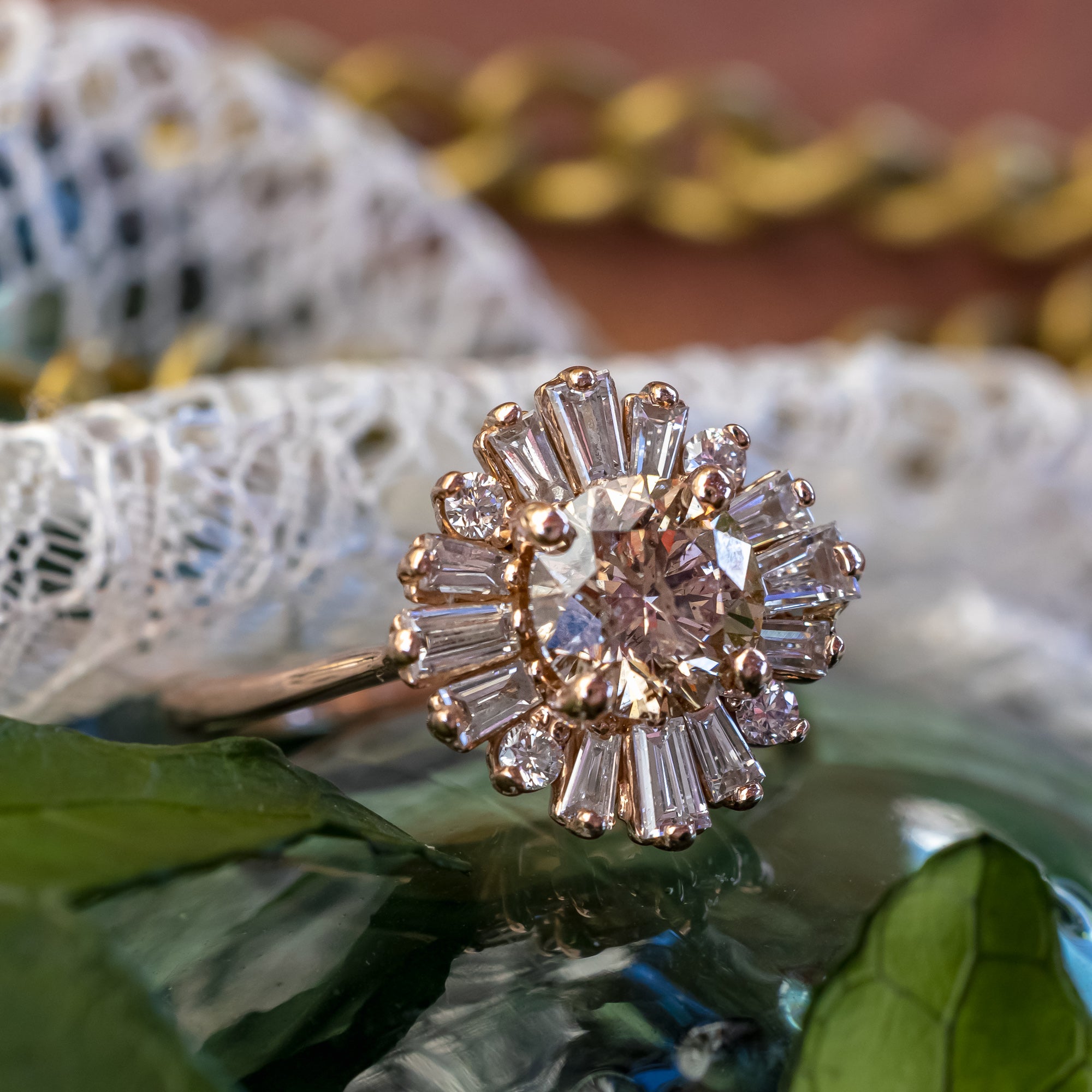 Rose gold ring with champagne diamond and diamond accents on a decorative surface
