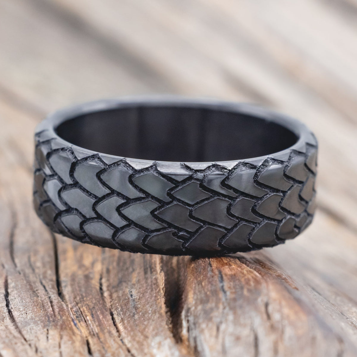 dragon scale engraved wedding band on wooden surface