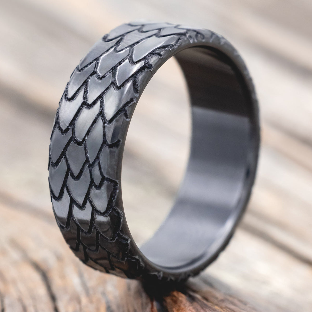 dragon scale engraved wedding band on wooden surface
