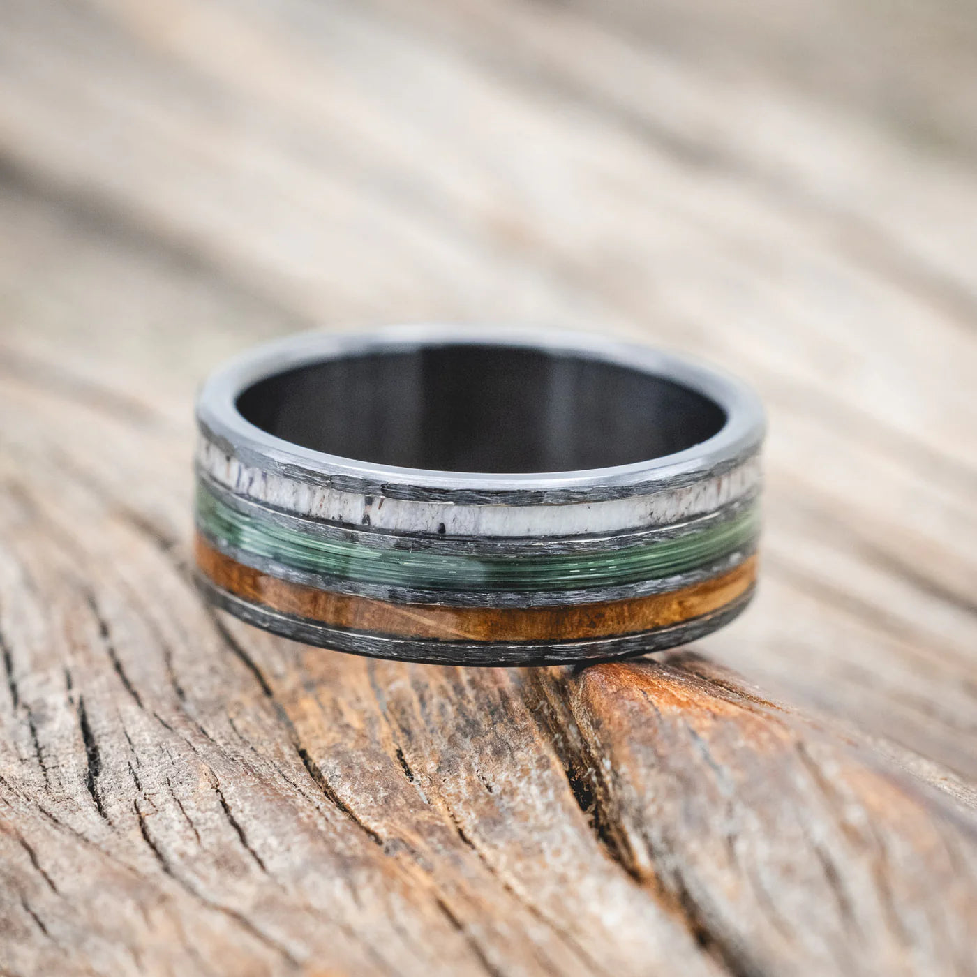 "RIO" - ANTLER, GREEN MONO FISHING LINE, AND WHISKEY BARREL OAK WEDDING BAND WITH A HAMMERED FINISH - BLACK ZIRCONIUM - SIZE 11 1/2-Staghead Designs