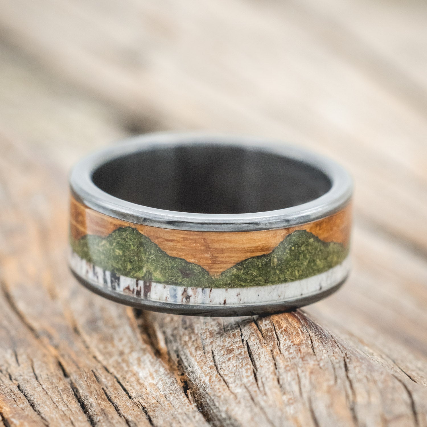 "Voyager" - men's wedding ring featuring moss-filled mountain engraving with whiskey barrel oak & antler inlays