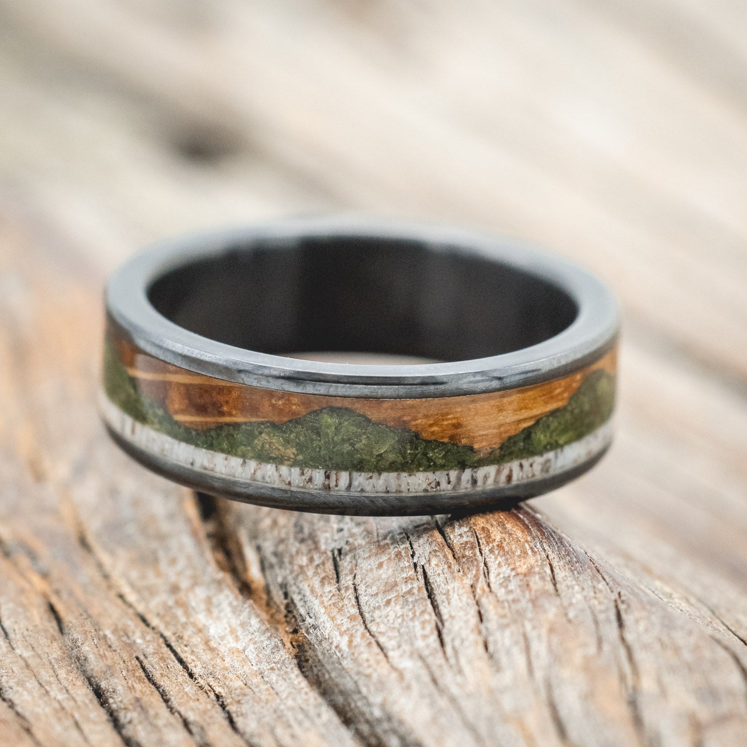"Voyager" - men's wedding ring featuring moss-filled mountain engraving with whiskey barrel oak & antler inlays