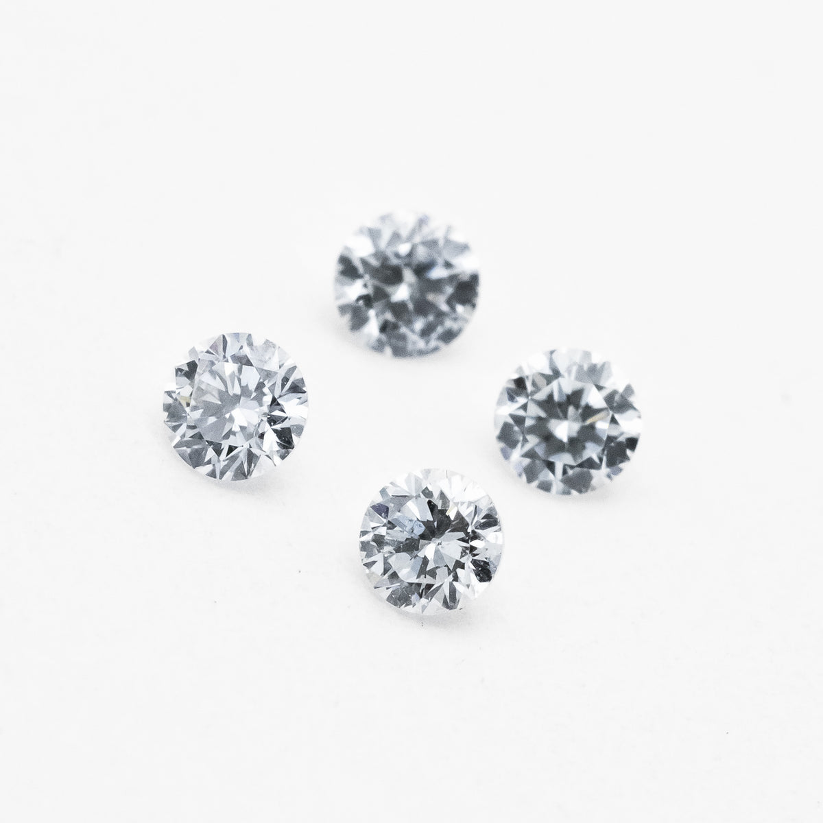 4 round white diamonds on white background