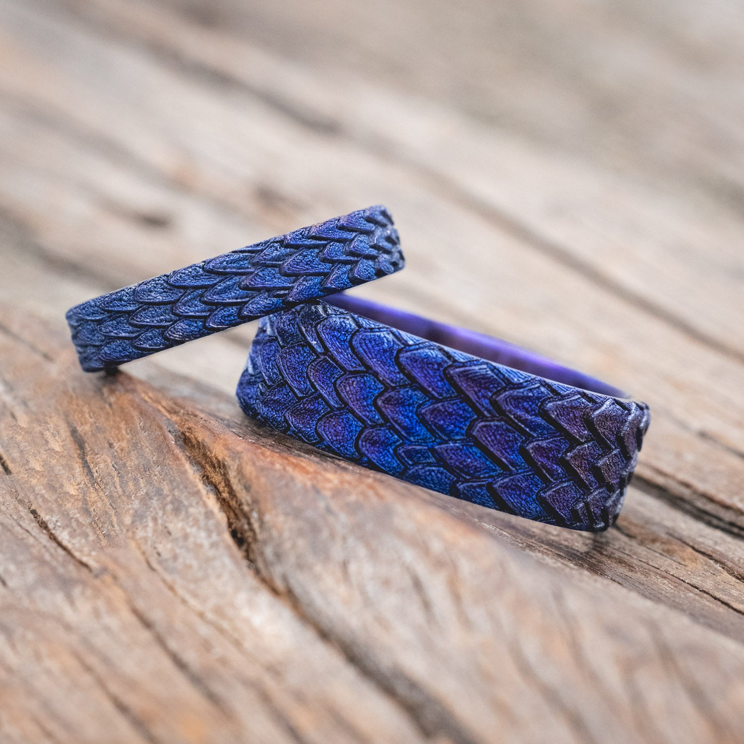 "Echo" matching wedding band set featuring fire-treated titanium with a custom embossed 3D dragon scale