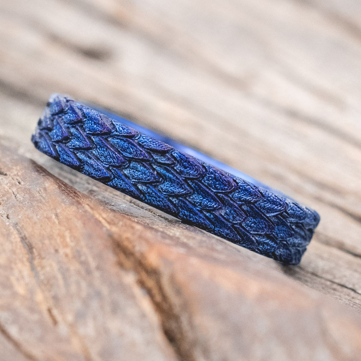 "Echo" thinner wedding band featuring fire-treated titanium with a custom embossed 3D dragon scale