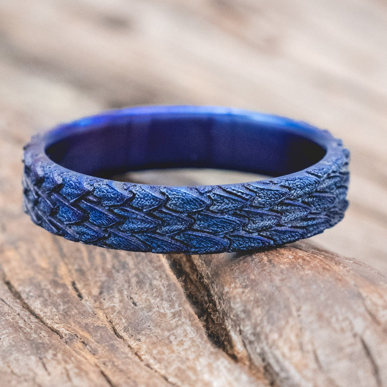 "Echo" thinner wedding band featuring fire-treated titanium with a custom embossed 3D dragon scale