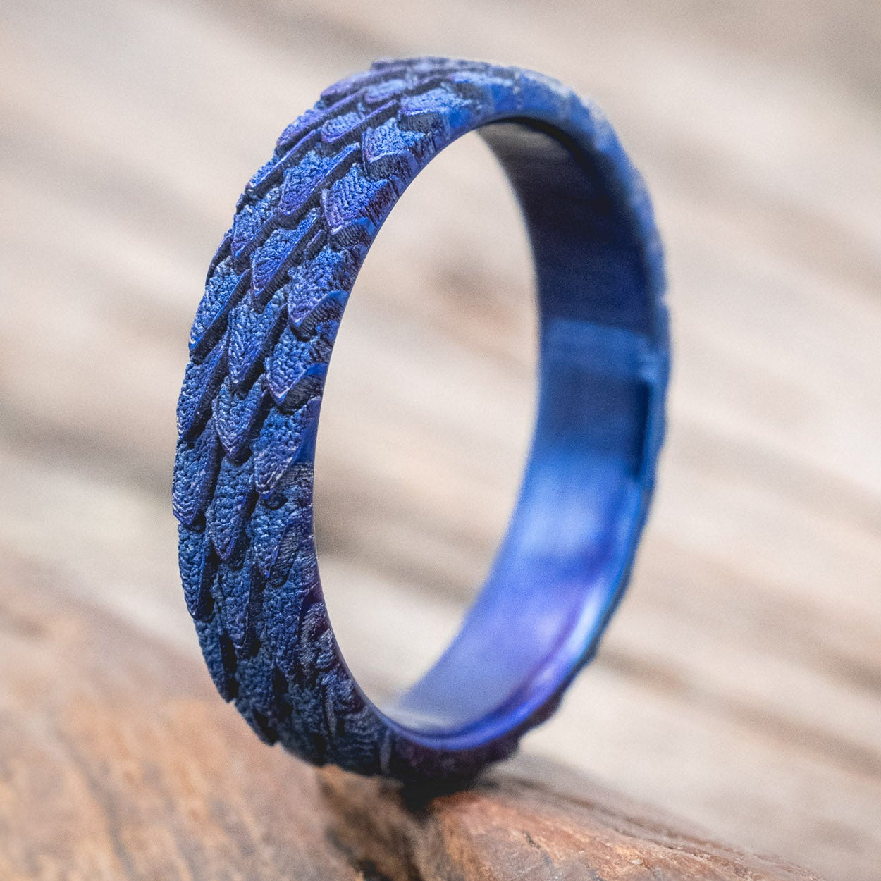 "Echo" thinner wedding band featuring fire-treated titanium with a custom embossed 3D dragon scale