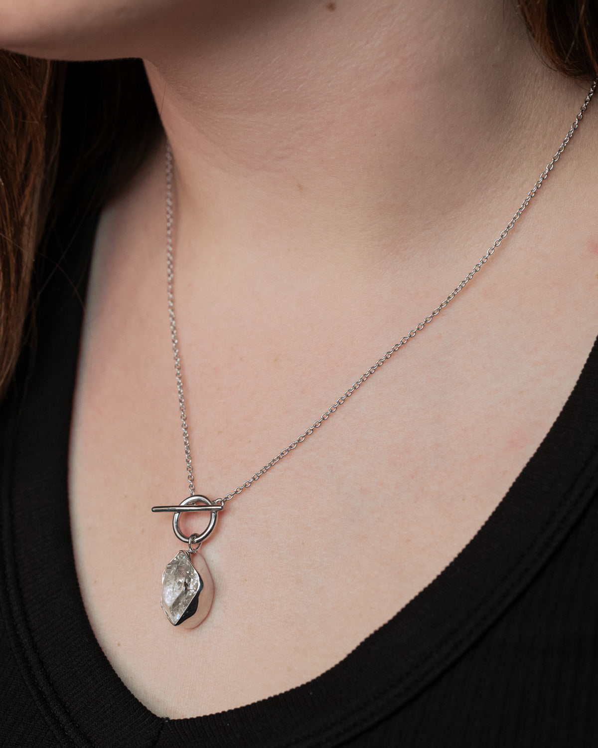 On neck photo of Rhodium Plated Herkimer Diamond Quartz Necklace with a 925 Sterling Silver base