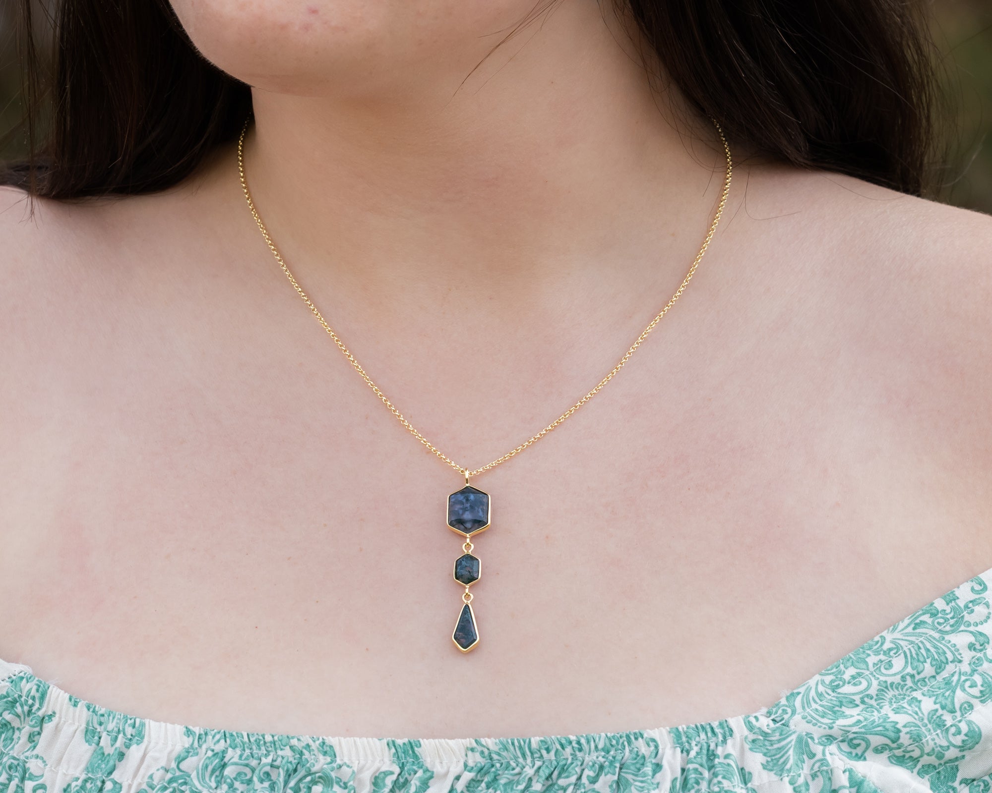 Necklace with moss agate and gold chain on a person