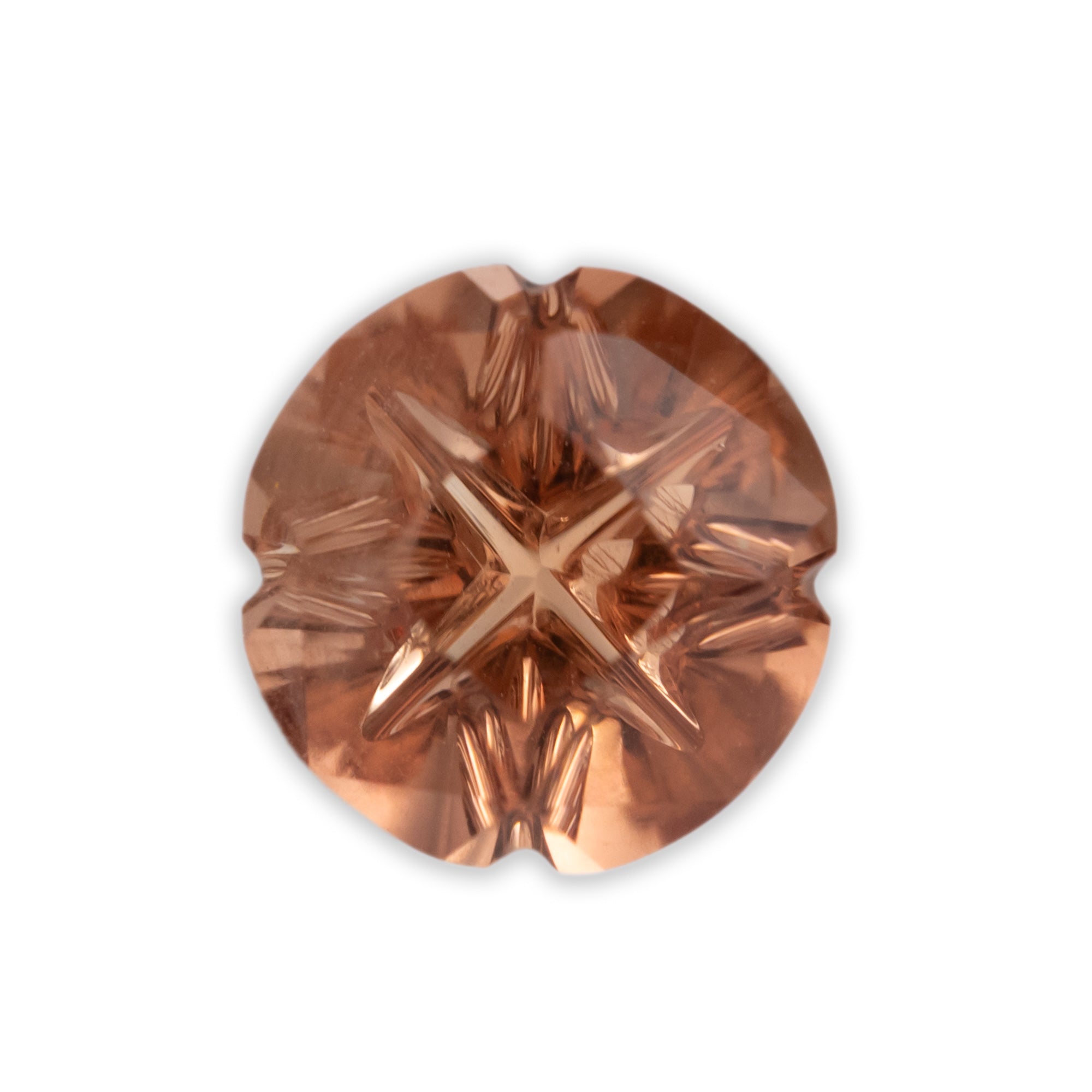 A round peach sunstone on a white background