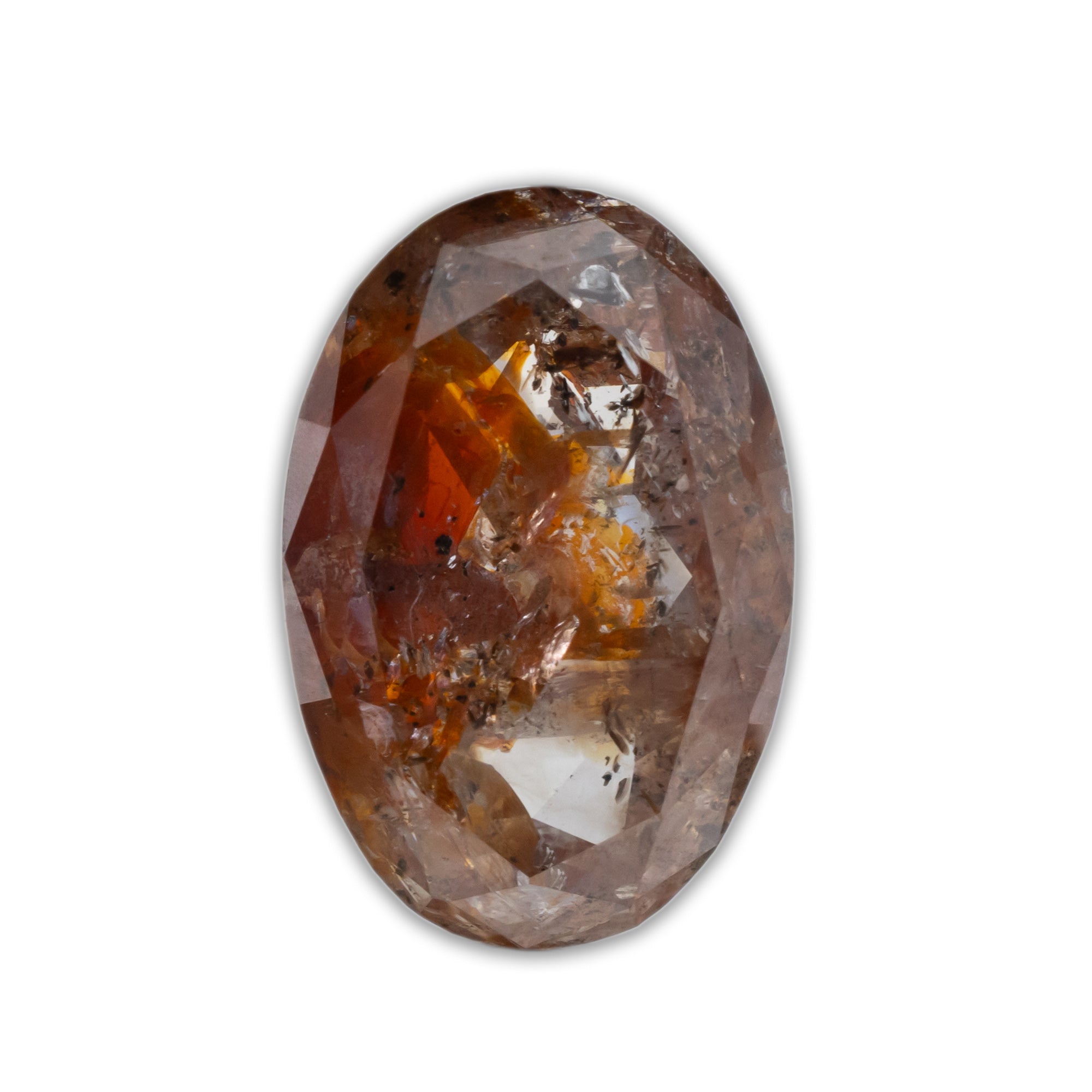 An oval-cut salt and pepper diamond with copper and black inclusions on a white background
