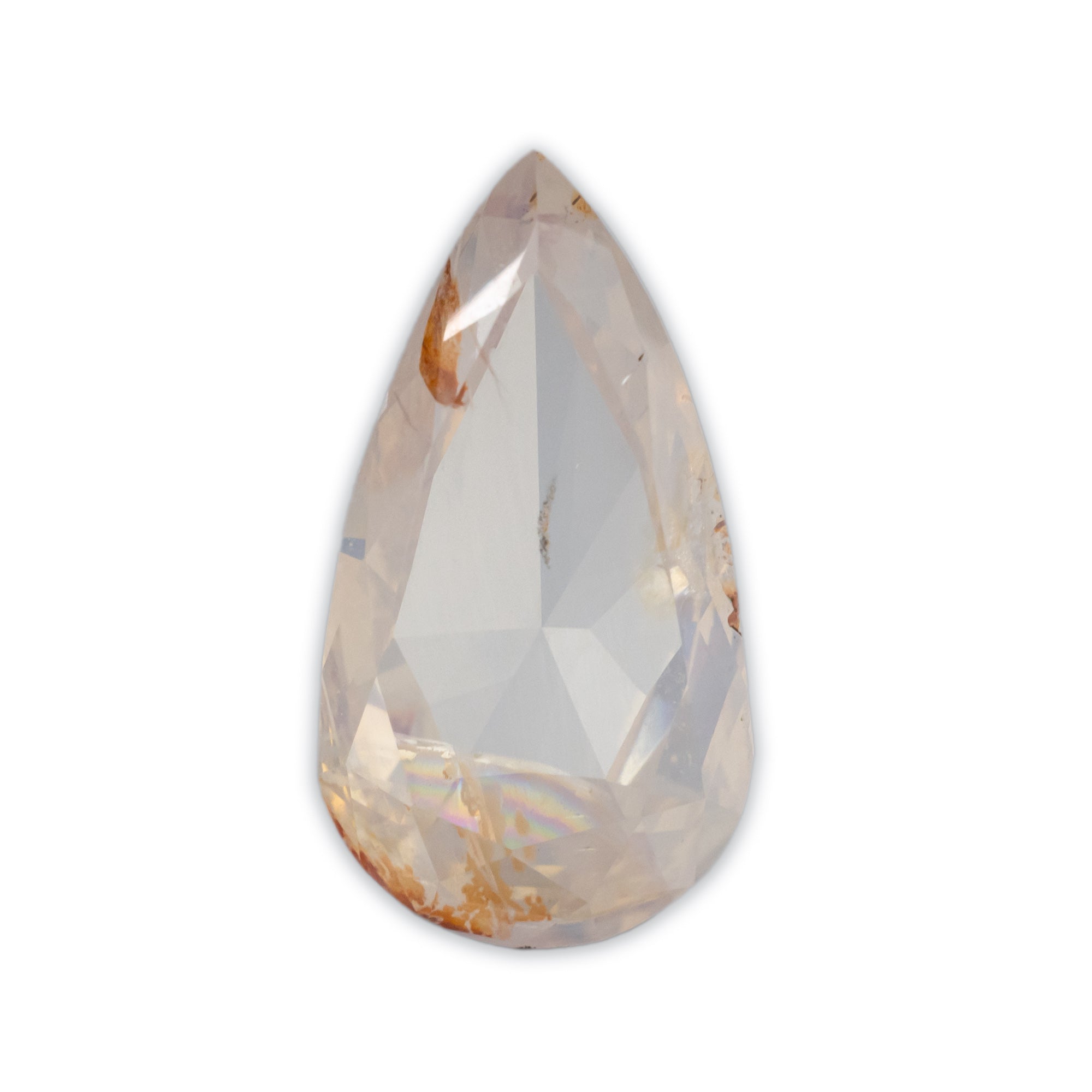 A pear cut salt & pepper diamond with a pale peachy-pink hue and subtle golden-brown inclusions, shown on a plain white background.