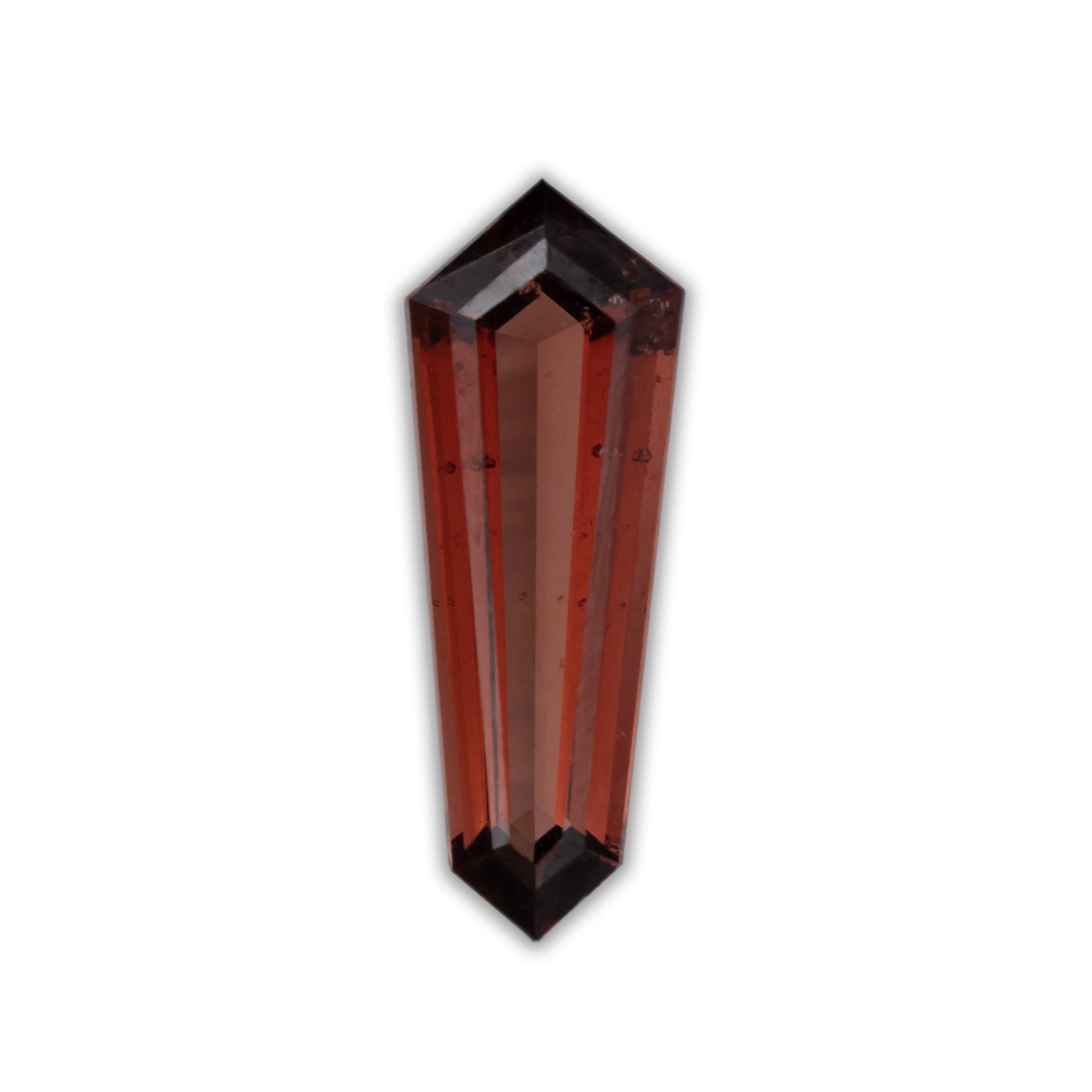 Faceted garnet with a red color on a white background