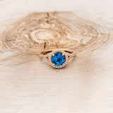 "AURA" - BIRTHSTONE RING WITH A SKY BLUE TOPAZ CENTER STONE WITH DIAMOND HALO & ACCENTS