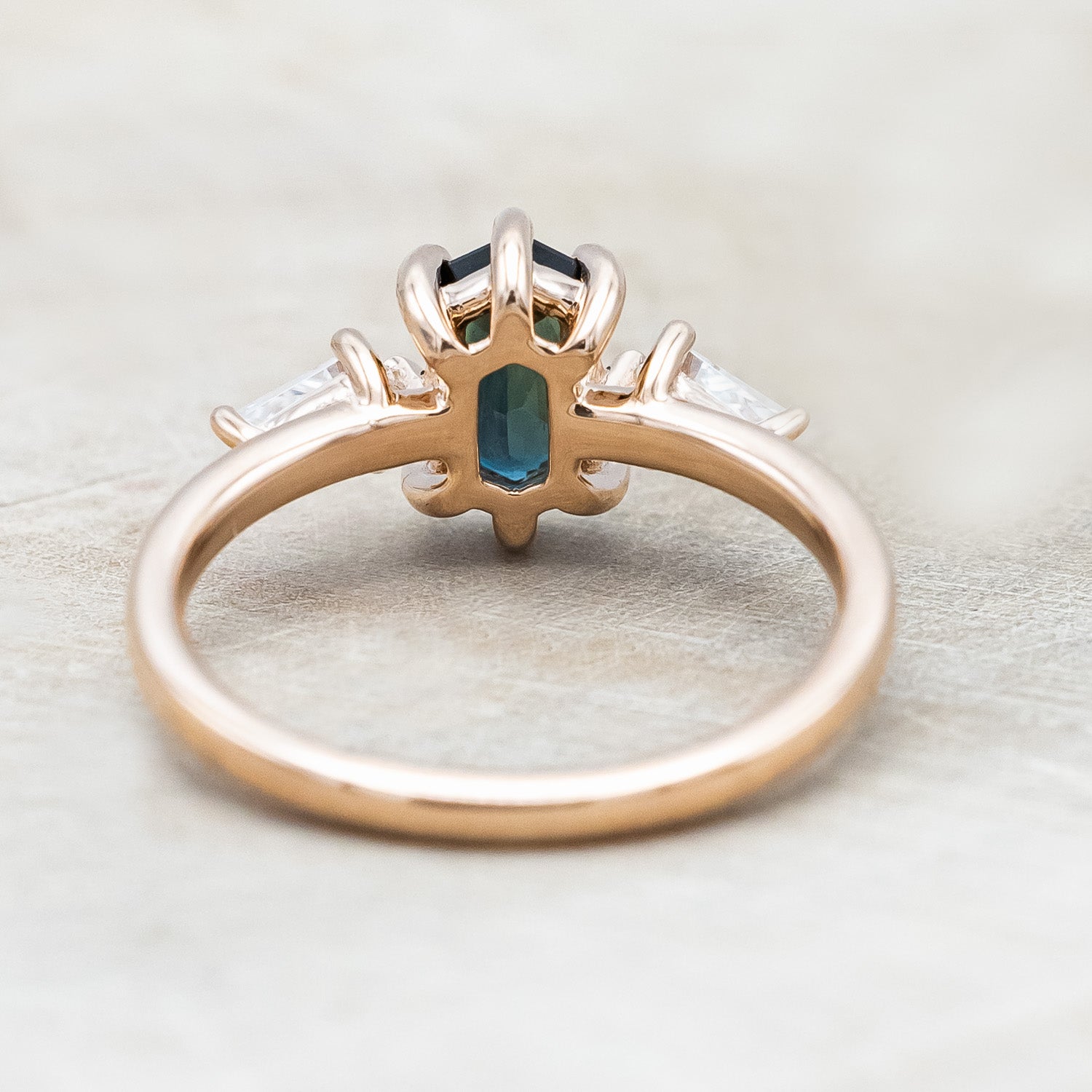 Back view  of "Isla" - elongated hexagon cut Australian sapphire with moissanite accents in 14K rose gold