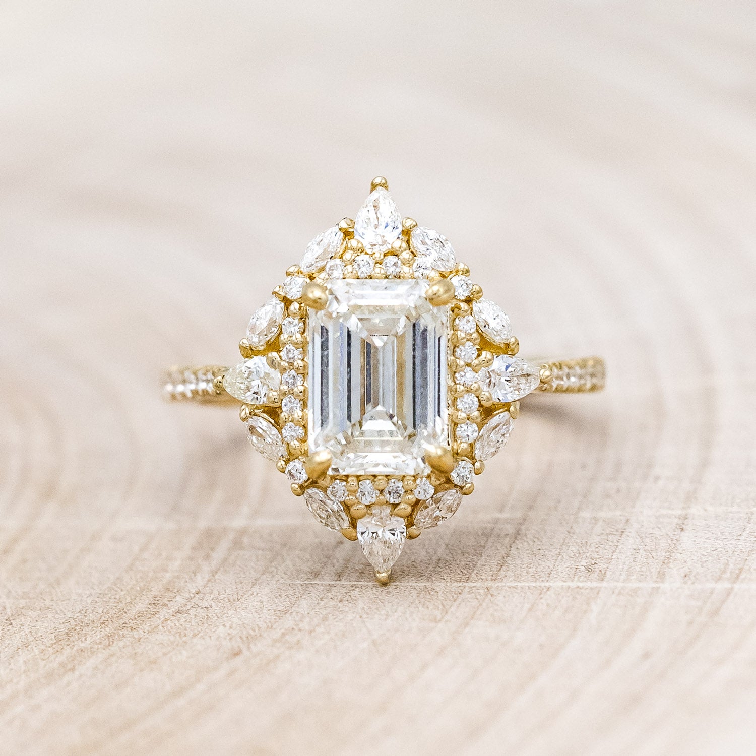 "North Star" - emerald cut diamond women's engagement ring with a diamond halo and accents on a 14K yellow gold band