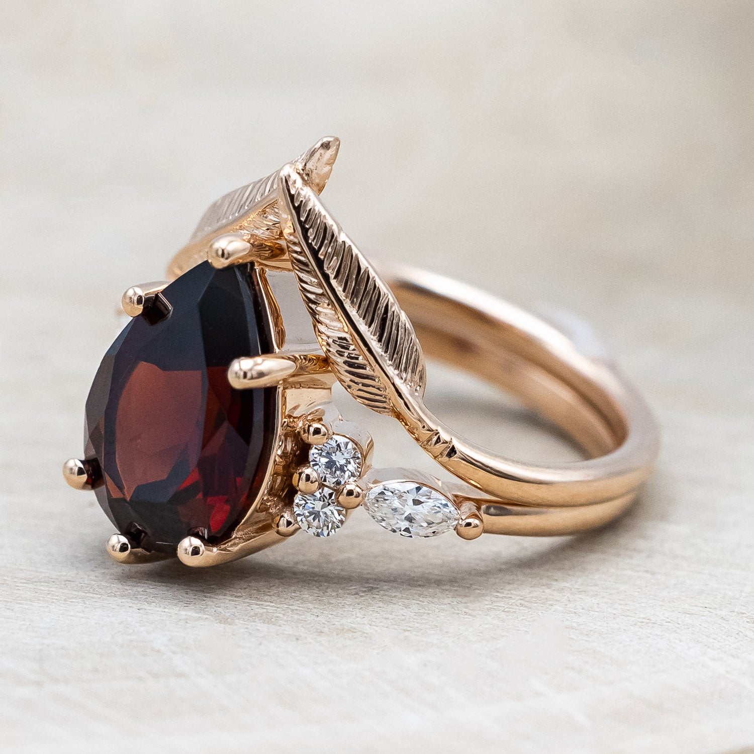 Side view of "Sage" - garnet women's engagement ring with diamond accents & "Fala" feather-style tracer