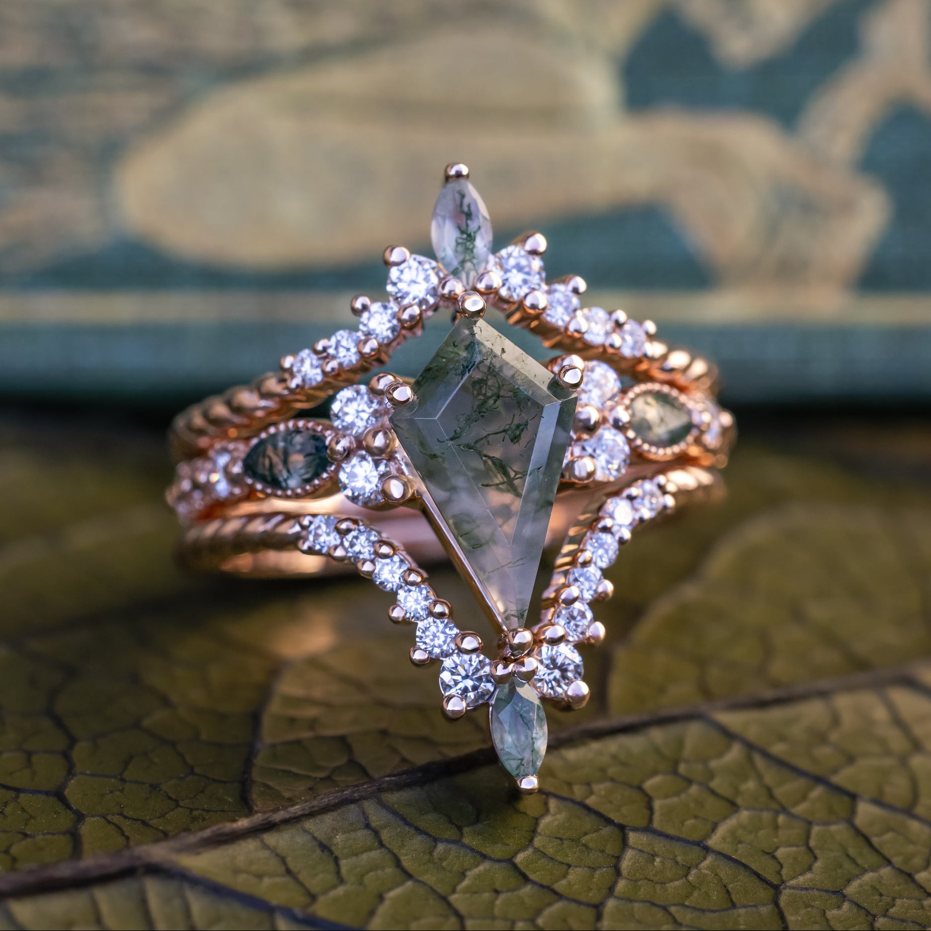"Shimmering Sage" - Bridal Suite - Kite Cut Moss Agate Engagement Ring With Marquise Moss Agate Accents & A Diamond Tracer-Staghead Designs