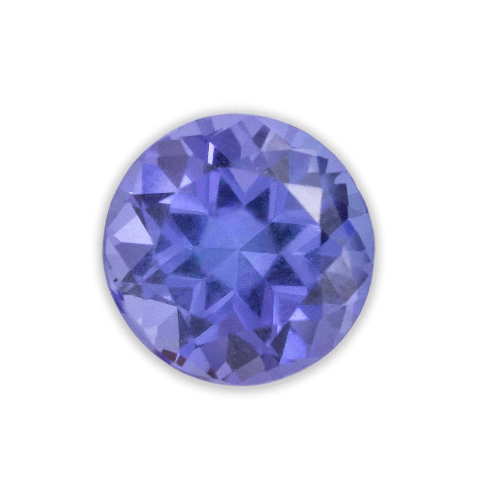 Round purple tanzanite on a white background