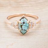 Shown here is "Raya", a turquoise women's engagement ring with diamond accents, front facing. Many other center stone options are available upon request.