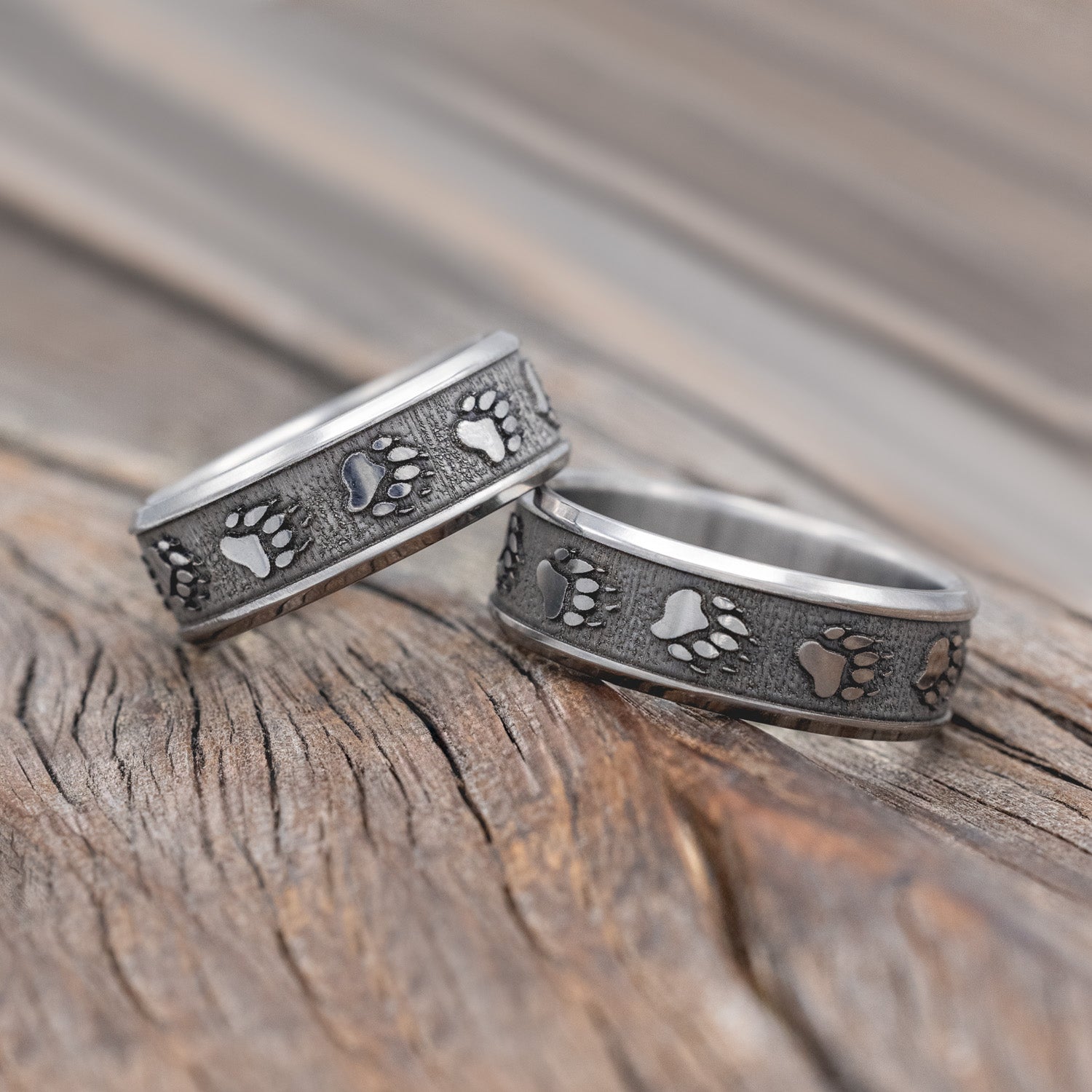 Matching set of two "Legacy" - embossed wedding rings with bear paw engravings on channel-style band. 