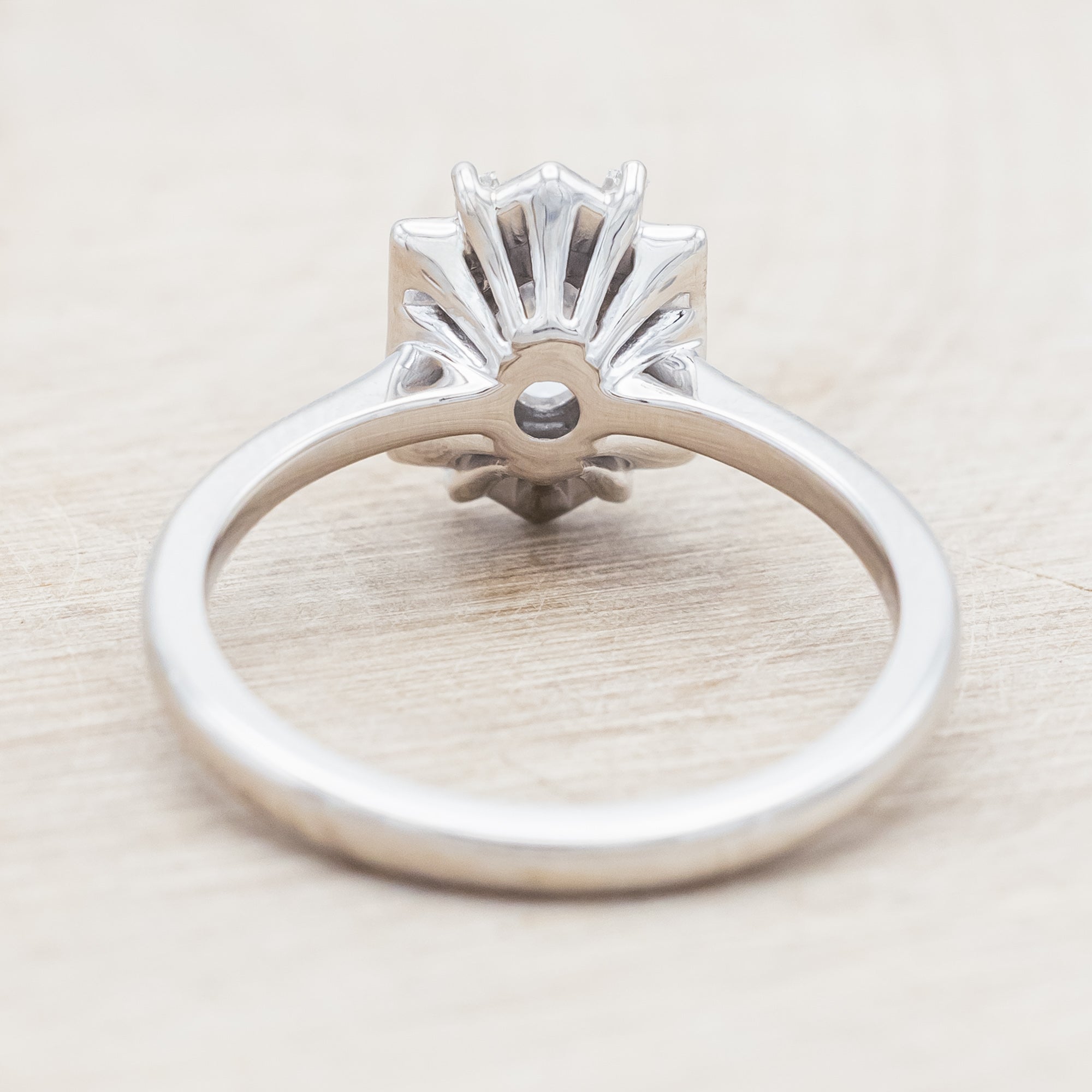 Lab diamond ring with genuine diamond accents against beige background
