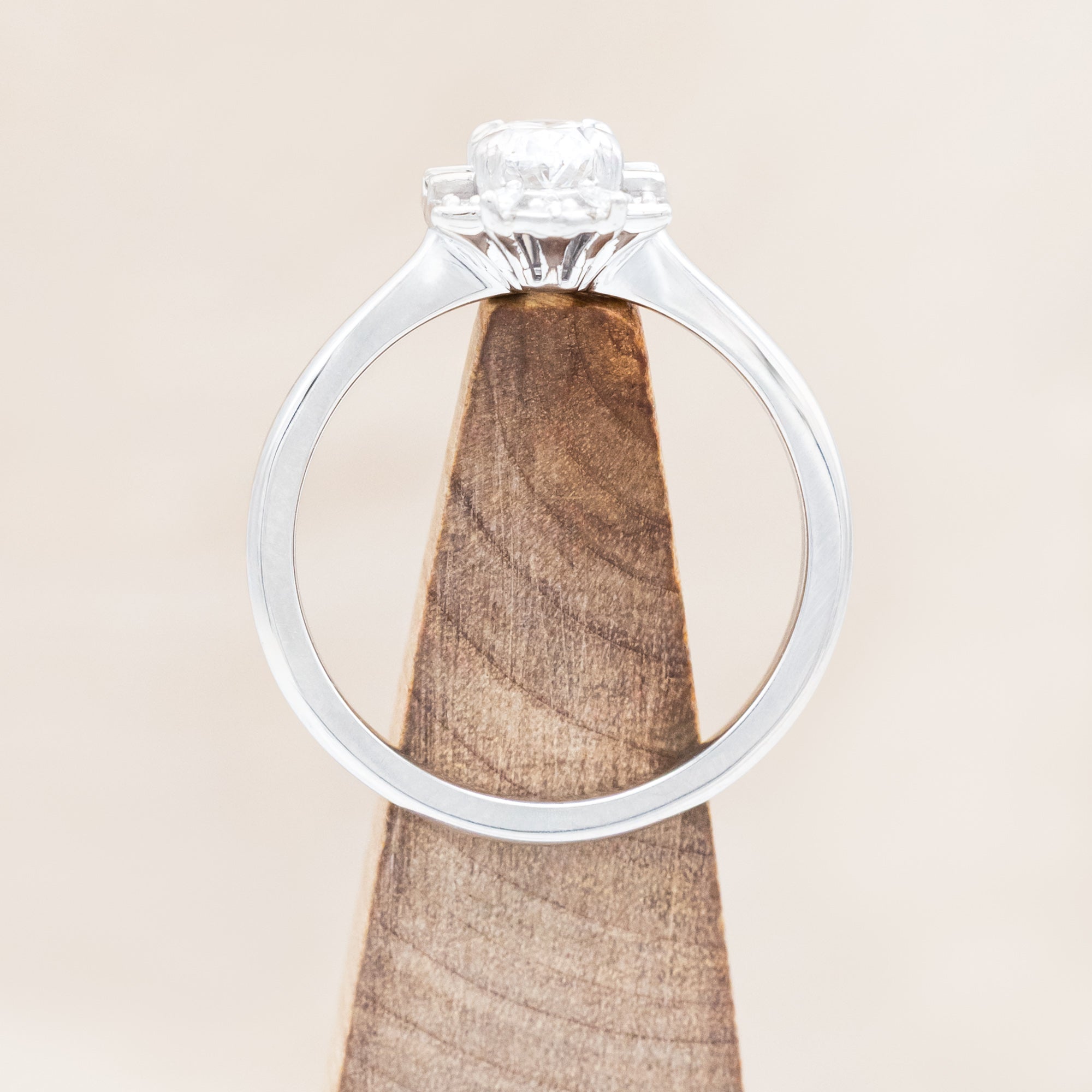 Lab diamond ring with genuine diamond accents against beige background