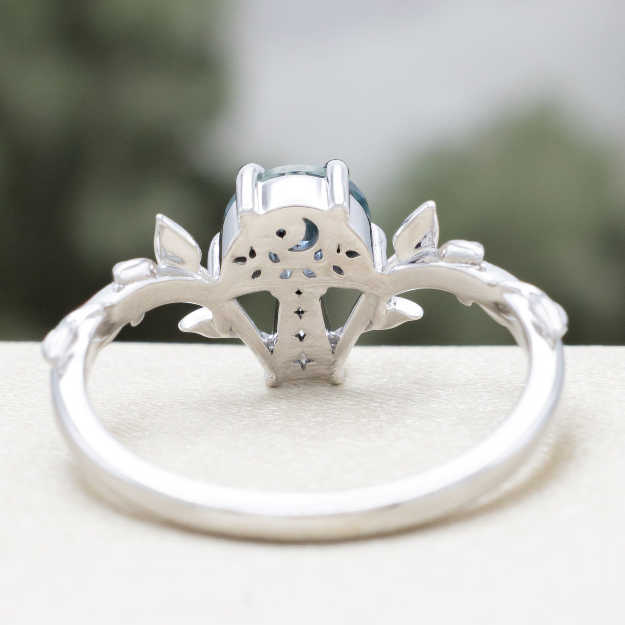 White gold mushroom ring with a blue sapphire on  a white surface