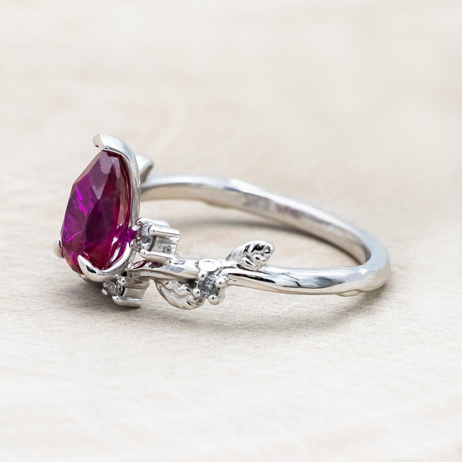 "Harlow" pear cut ruby engagement ring with salt & pepper diamond accents on a branch-inspired band