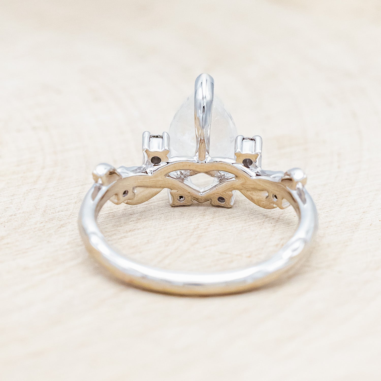 Back view of "Harlow" - moonstone women's engagement ring with salt & pepper diamond accents on a branch-inspired band