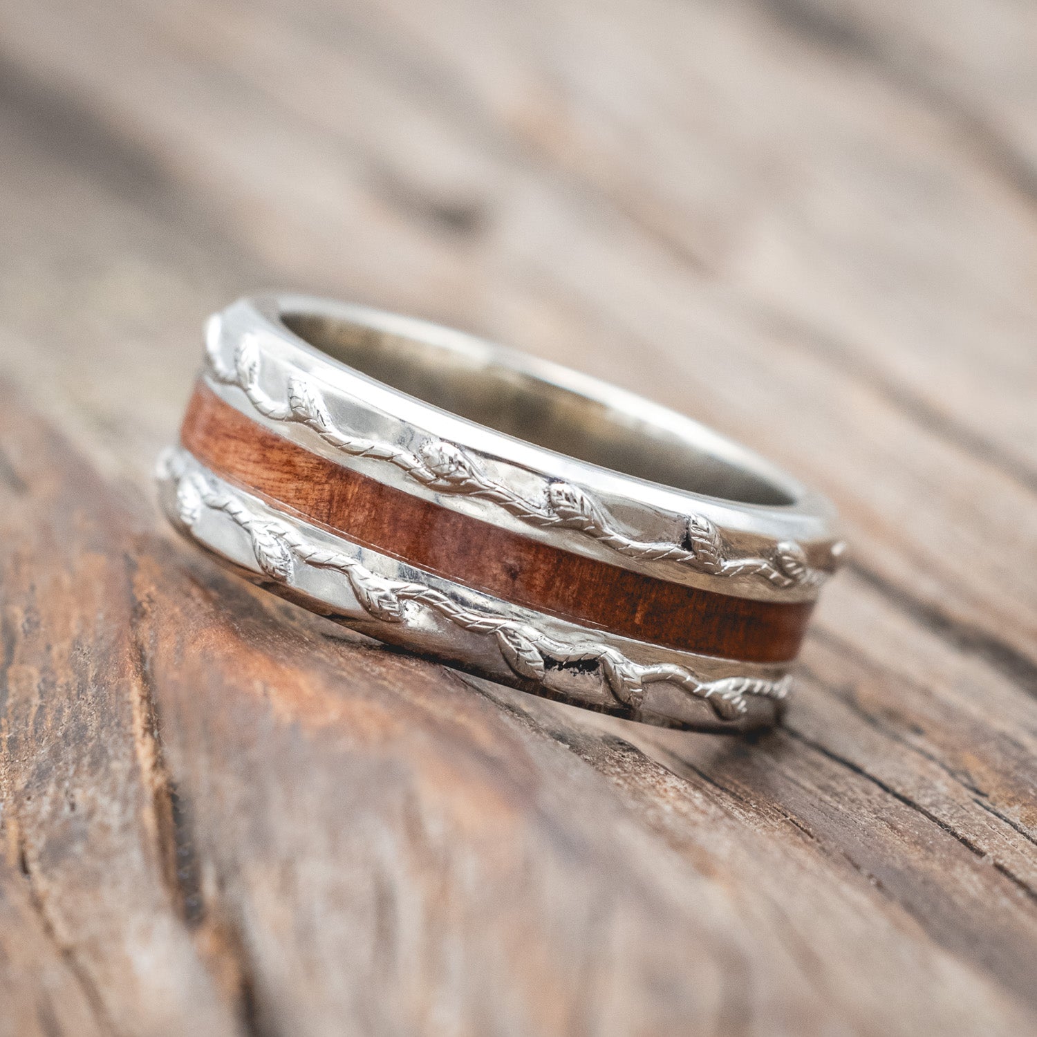 "Nirvana" men's wedding ring with centered redwood inlay and embossed vine in 14K white gold