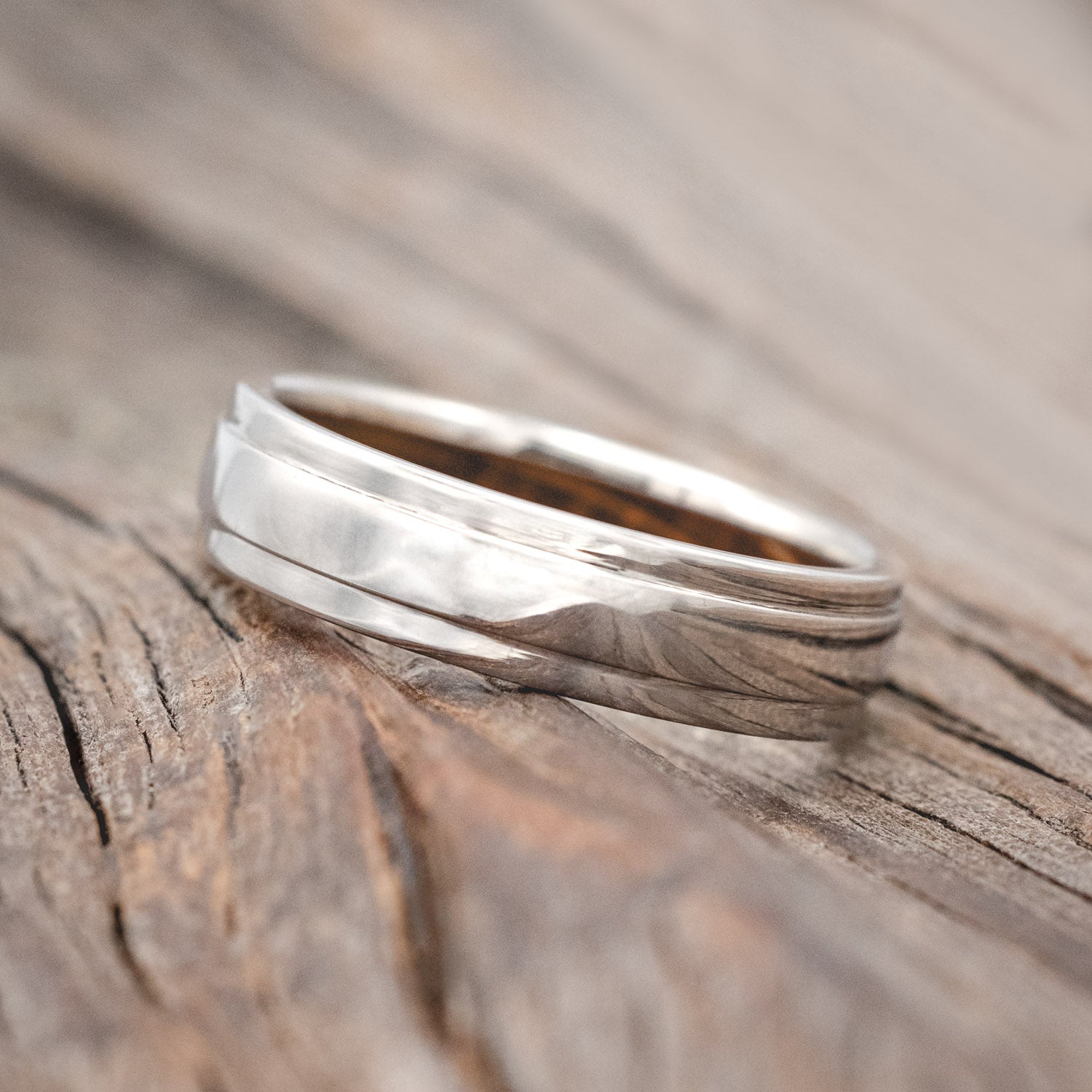 "SEDONA" - RAISED CENTER WEDDING RING FEATURING A WHISKEY BARREL LINED 14K GOLD BAND-Staghead Designs