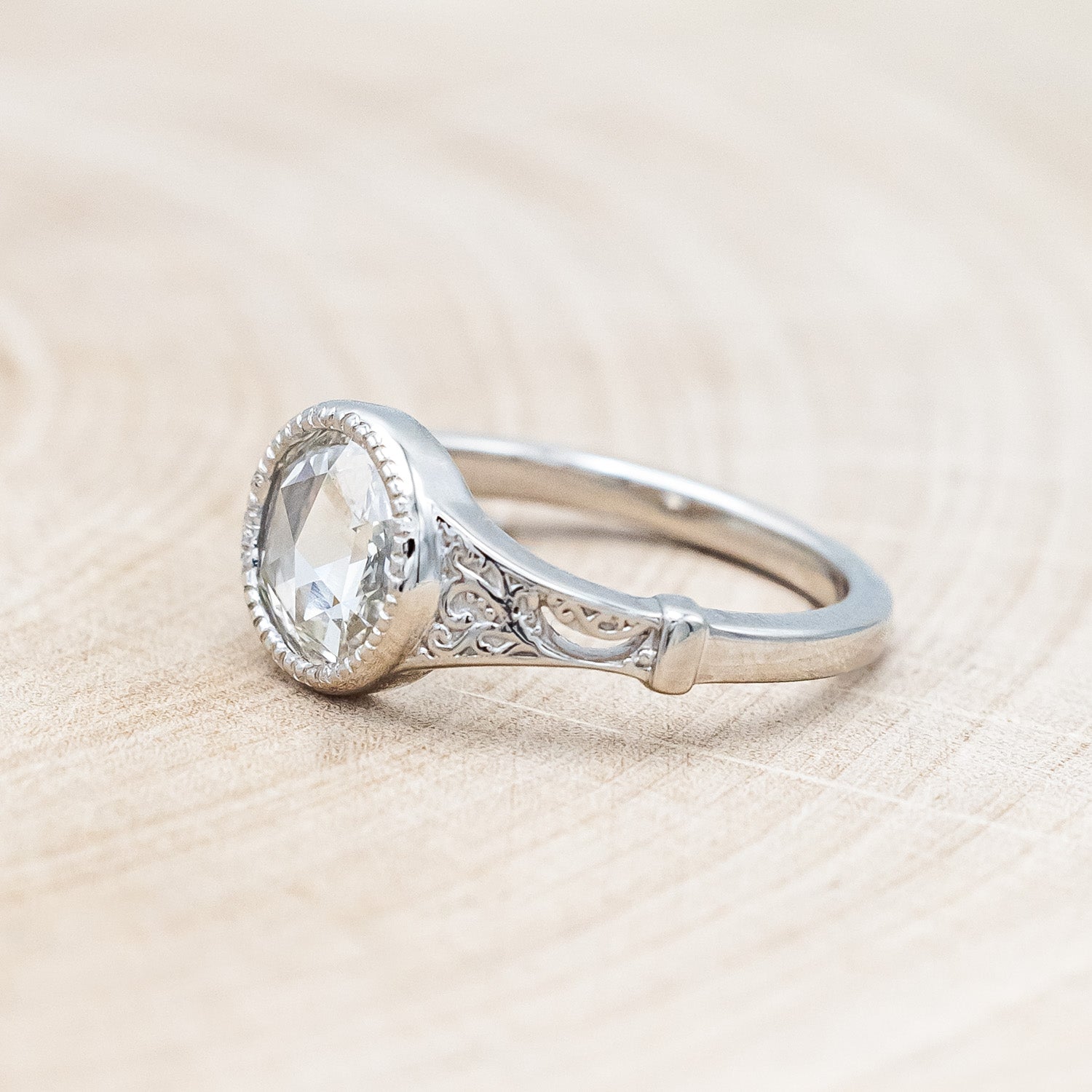 Side view of "Selene" - round lab-grown diamond women's engagement ring with crescent moon engravings in 14K white gold
