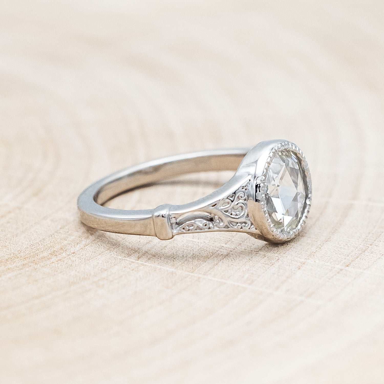 Side view of "Selene" - round lab-grown diamond women's engagement ring with crescent moon engravings in 14K white gold