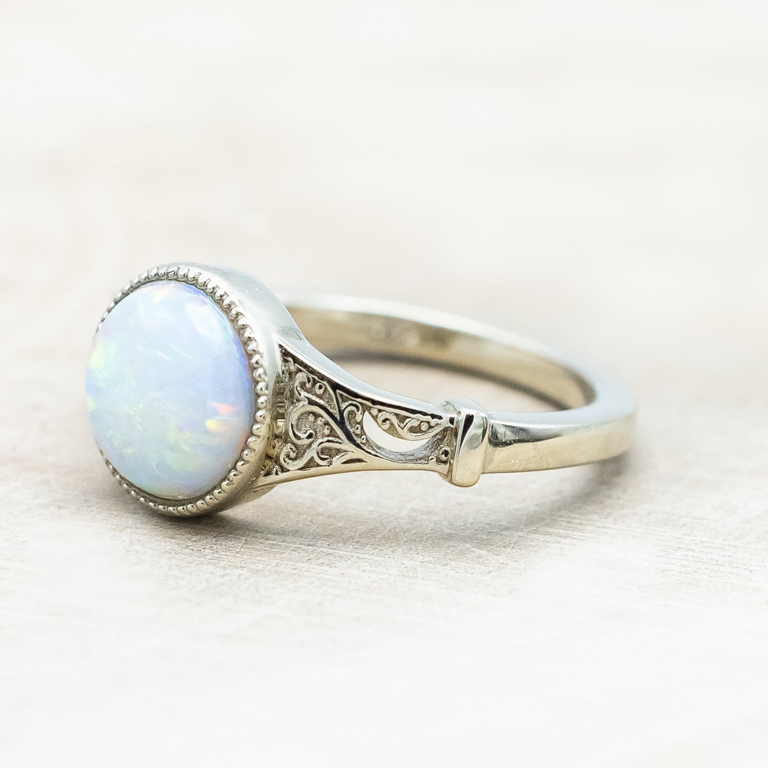 Side view of "Selene"  - Australian opal women's engagement ring with crescent moon engravings in 14K white gold