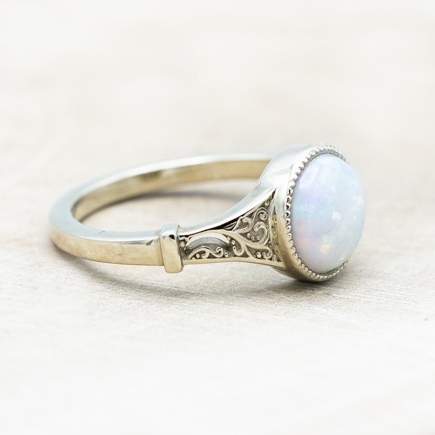Side view of "Selene"  - Australian opal women's engagement ring with crescent moon engravings in 14K white gold