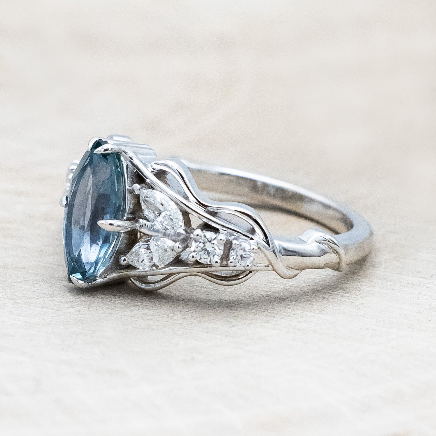 Side view of "Amarie" - diamond accented engagement ring with an abstract filigree cutout