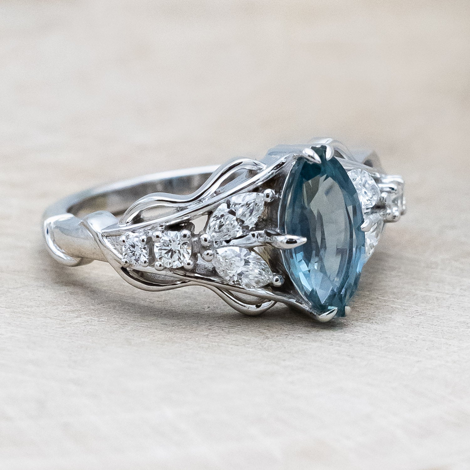 Side view of "Amarie" - diamond accented engagement ring with an abstract filigree cutout