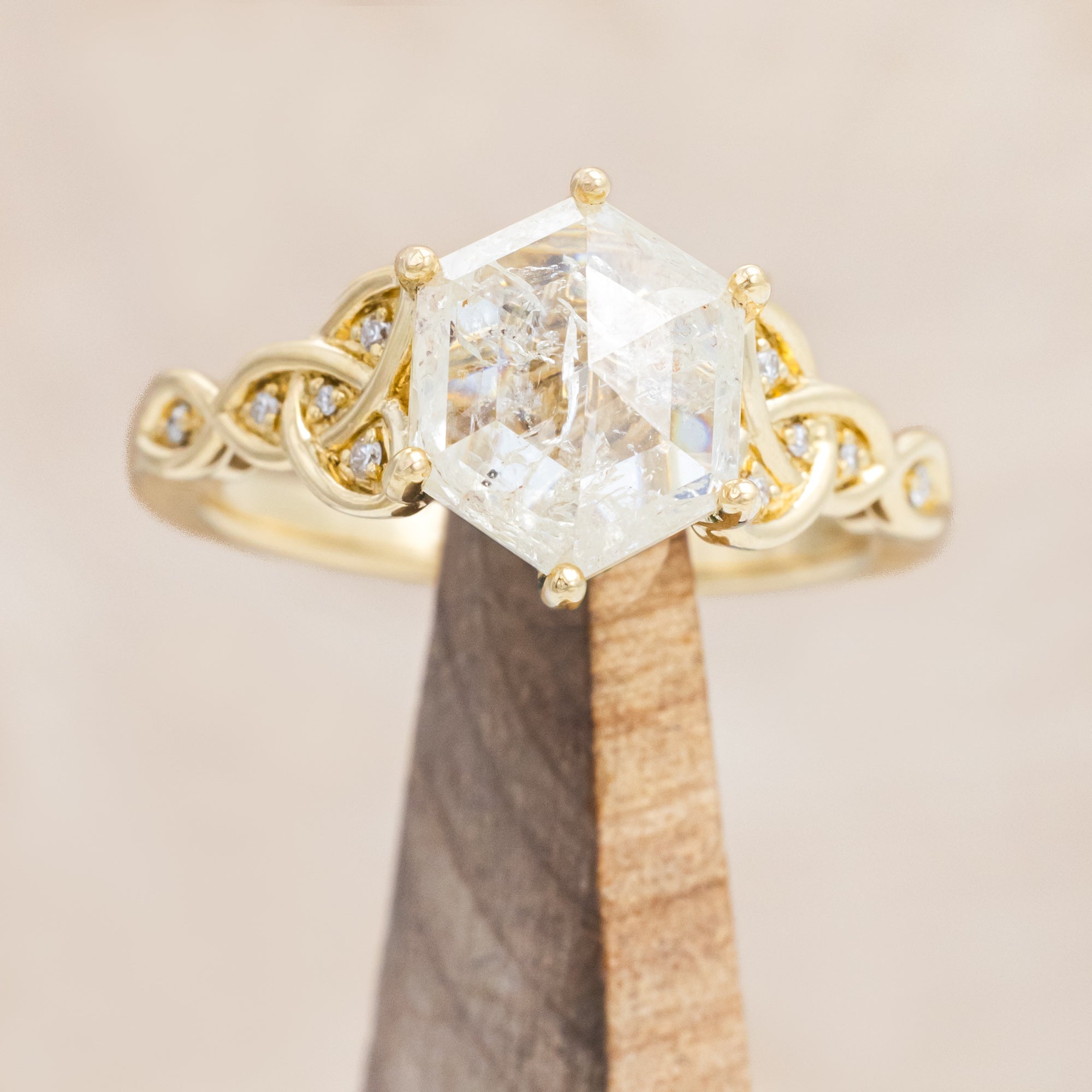 14K gold ring with an icy salt & pepper diamond on a beige background